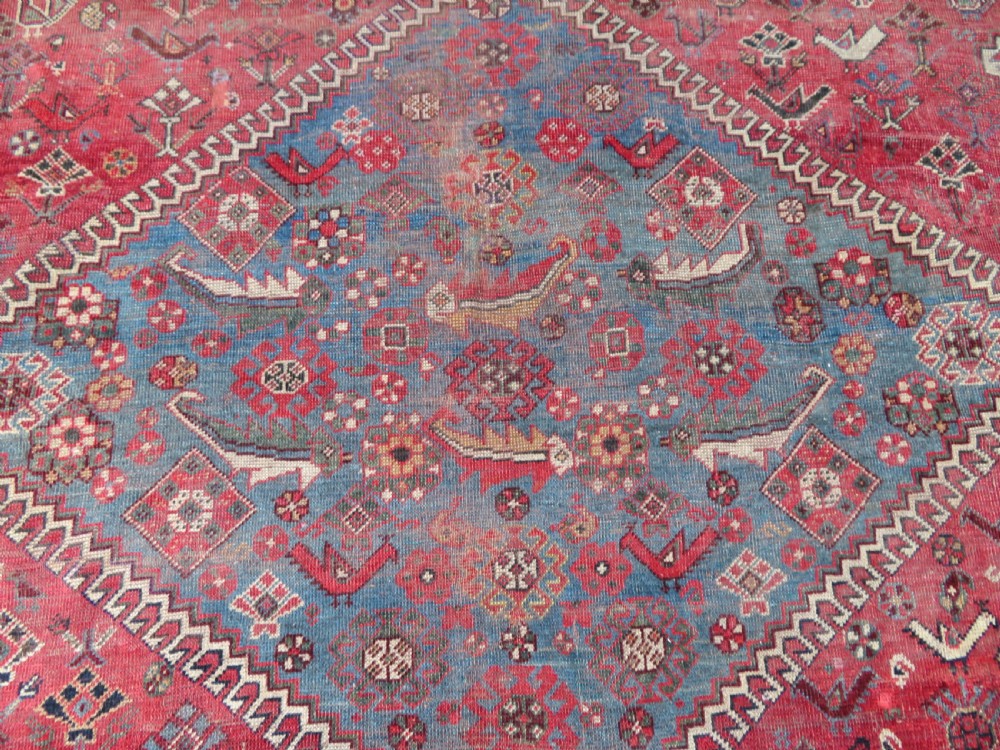 A long hand-knotted antique Persian Khamseh carpet featuring geometric diamond medallions and intricate tribal motifs in red, blue, and cream tones. View XVI