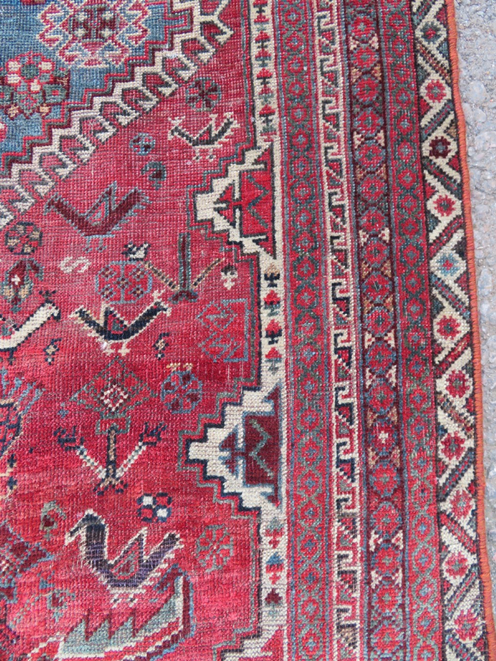 A long hand-knotted antique Persian Khamseh carpet featuring geometric diamond medallions and intricate tribal motifs in red, blue, and cream tones. View XIX