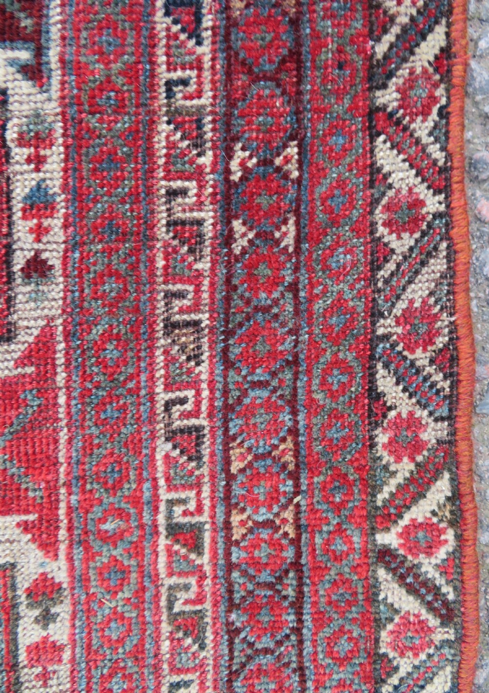 A long hand-knotted antique Persian Khamseh carpet featuring geometric diamond medallions and intricate tribal motifs in red, blue, and cream tones. View XX