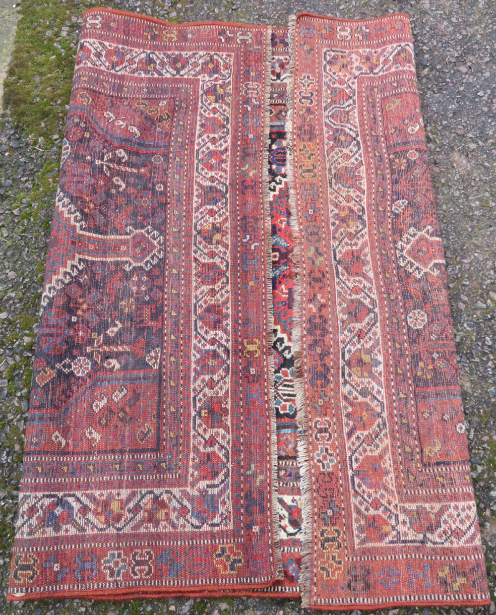 An antique Persian Qashqai hand-knotted wool rug with a dark navy blue field, double red geometric medallion, and multi-band patterned borders. View XII