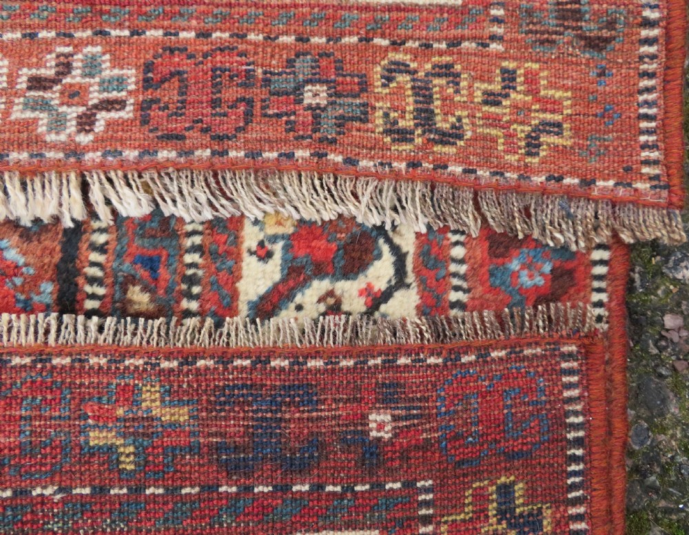 An antique Persian Qashqai hand-knotted wool rug with a dark navy blue field, double red geometric medallion, and multi-band patterned borders. View XIII