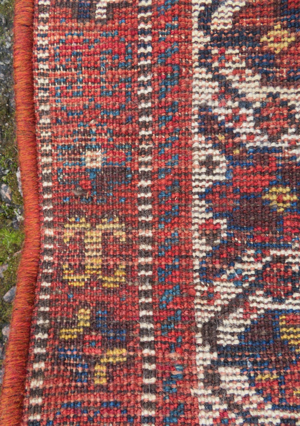 An antique Persian Qashqai hand-knotted wool rug with a dark navy blue field, double red geometric medallion, and multi-band patterned borders. View XV