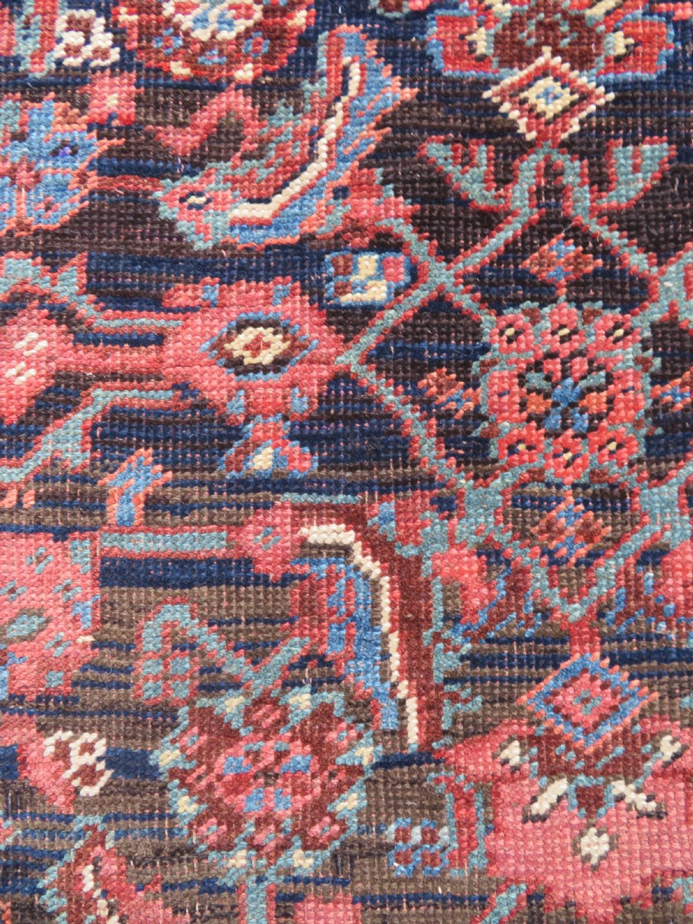 An antique Persian Bidjar Kelleh wool long rug featuring a central navy blue geometric botanical field surrounded by terracotta and blue borders. View IX