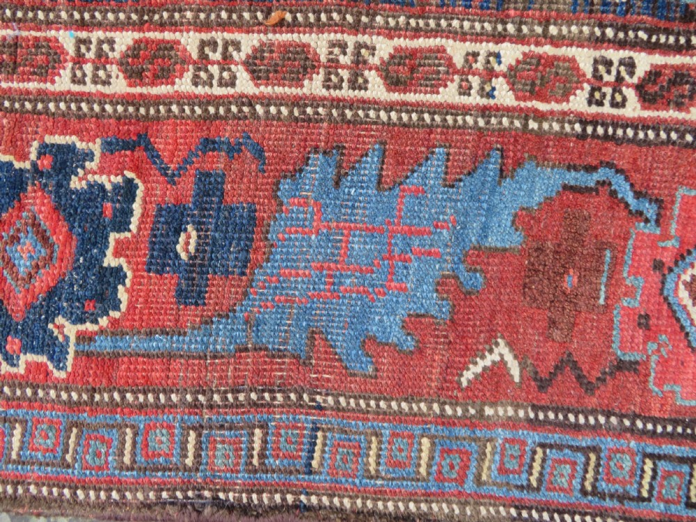 An antique Persian Bidjar Kelleh wool long rug featuring a central navy blue geometric botanical field surrounded by terracotta and blue borders. View XII
