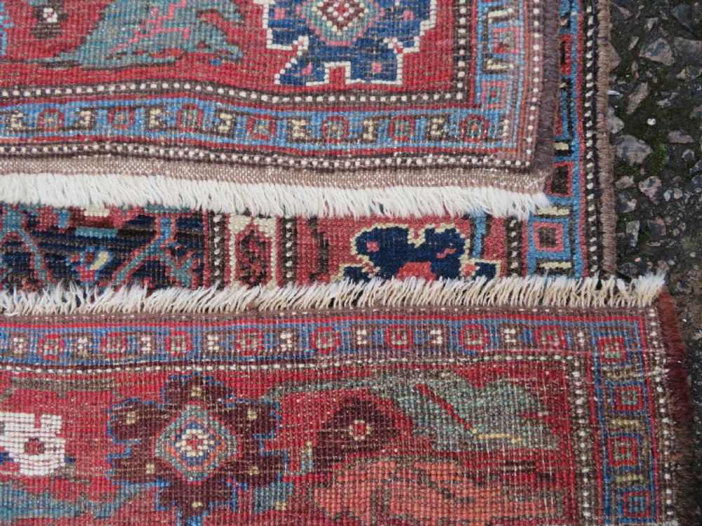 An antique Persian Bidjar Kelleh wool long rug featuring a central navy blue geometric botanical field surrounded by terracotta and blue borders. View XV
