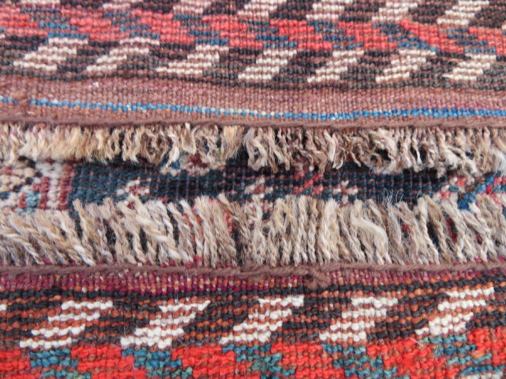 An antique Khamseh hand-knotted wool carpet featuring repeating stylised boteh motifs on a dark navy field with multi-banded geometric borders. View XXIII