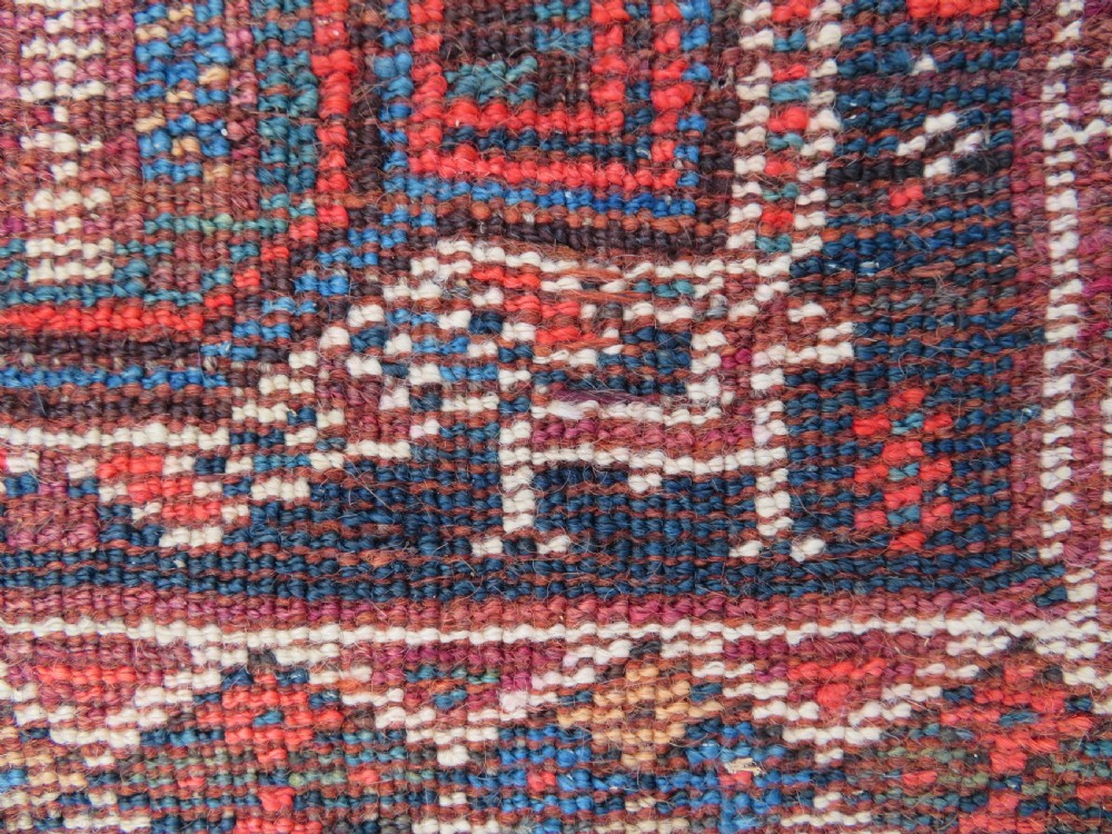 An antique Khamseh hand-knotted wool carpet featuring repeating stylised boteh motifs on a dark navy field with multi-banded geometric borders. View XXIV