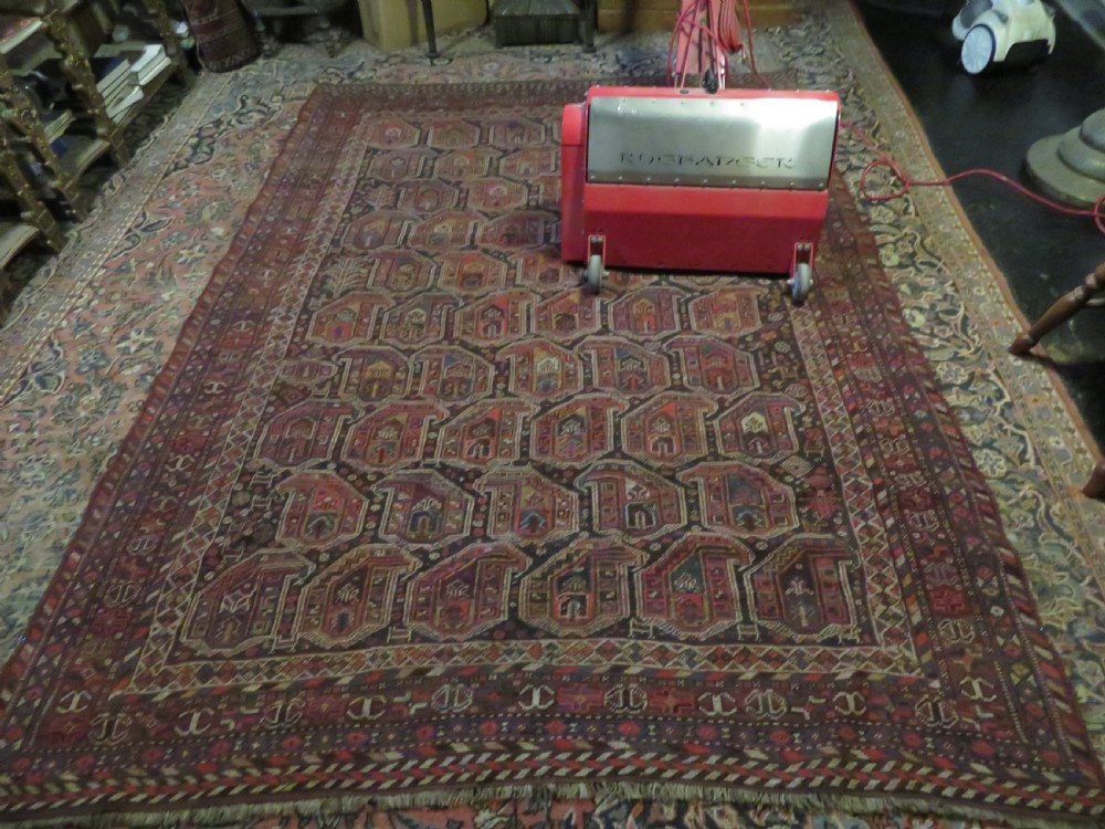 An antique Khamseh hand-knotted wool carpet featuring repeating stylised boteh motifs on a dark navy field with multi-banded geometric borders. View XXIX