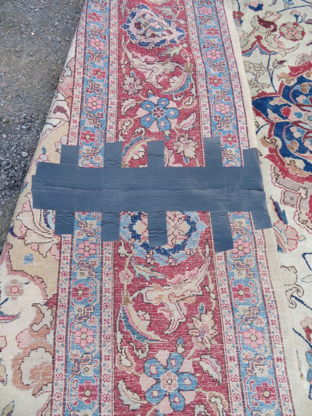 A large hand-knotted Persian Tabriz carpet featuring a central navy blue and red medallion on a cream field with floral vines and a prominent red border. View XVI