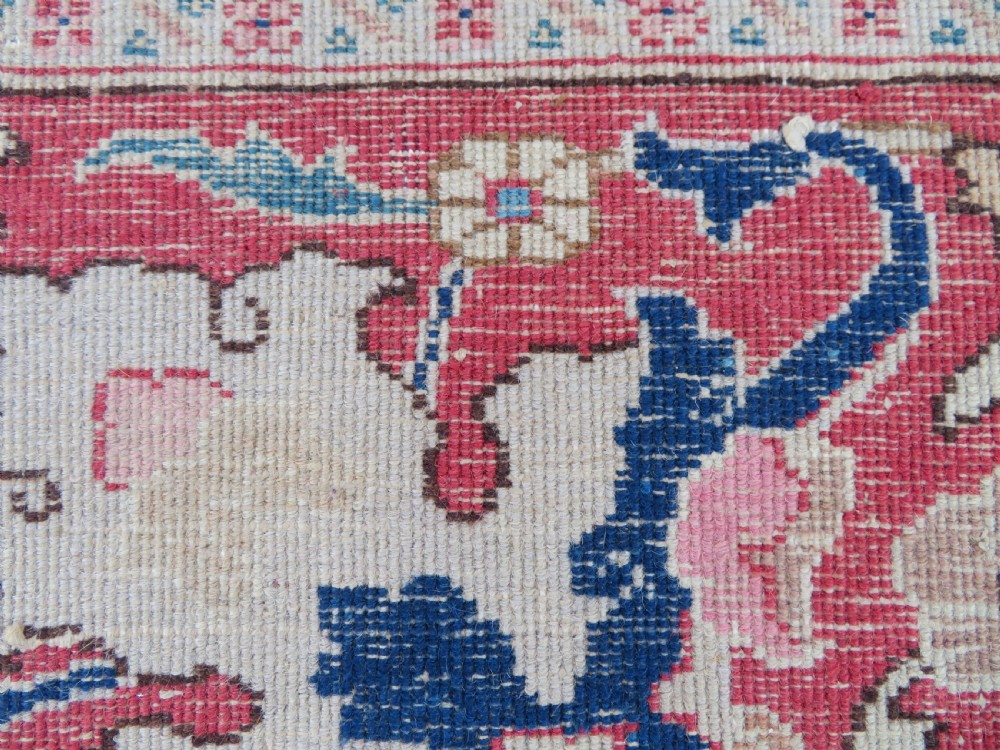 A large hand-knotted Persian Tabriz carpet featuring a central navy blue and red medallion on a cream field with floral vines and a prominent red border. View XVIII