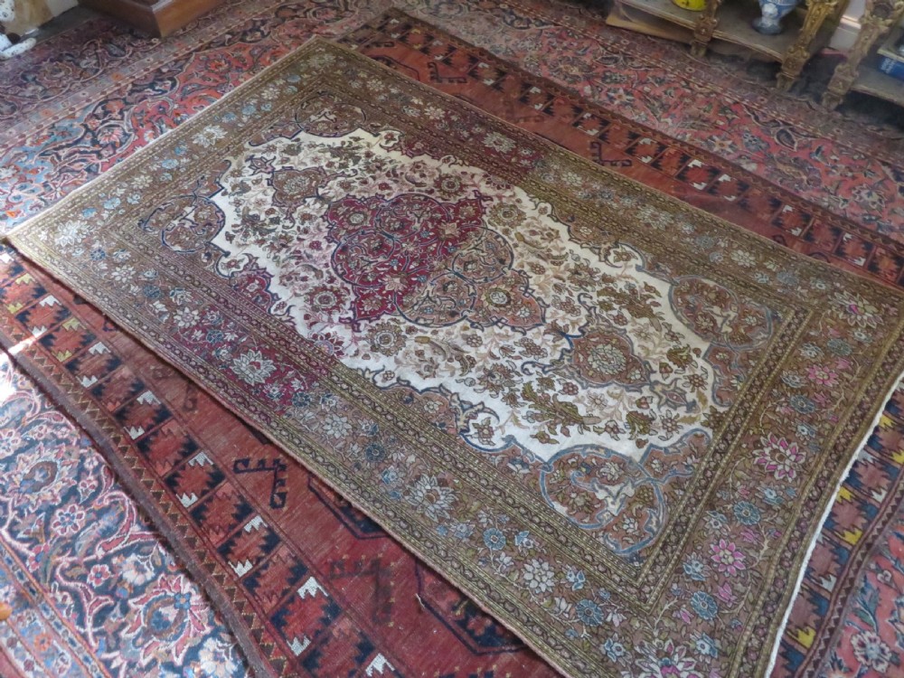 An antique hand-knotted Isfahan wool rug featuring a red central floral medallion on an ivory field surrounded by terracotta and blue floral borders. View XIV