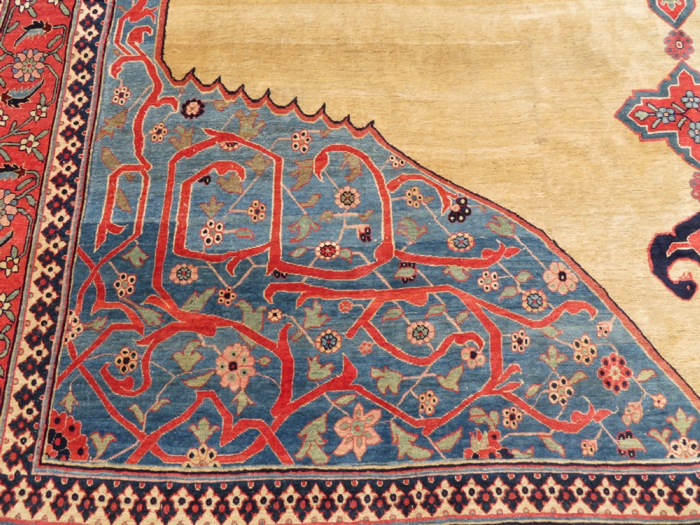 A large hand-knotted antique Persian Bidjar carpet featuring a gold yellow field, central diamond medallion, blue corner spandrels, and a patterned red border. View VI