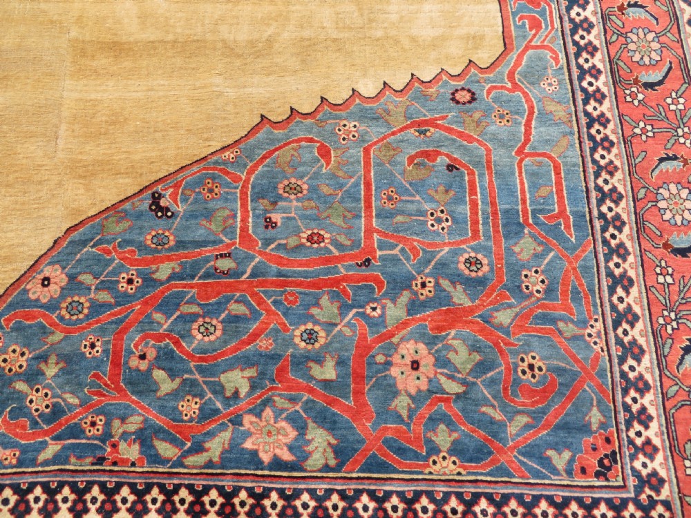 A large hand-knotted antique Persian Bidjar carpet featuring a gold yellow field, central diamond medallion, blue corner spandrels, and a patterned red border. View VII