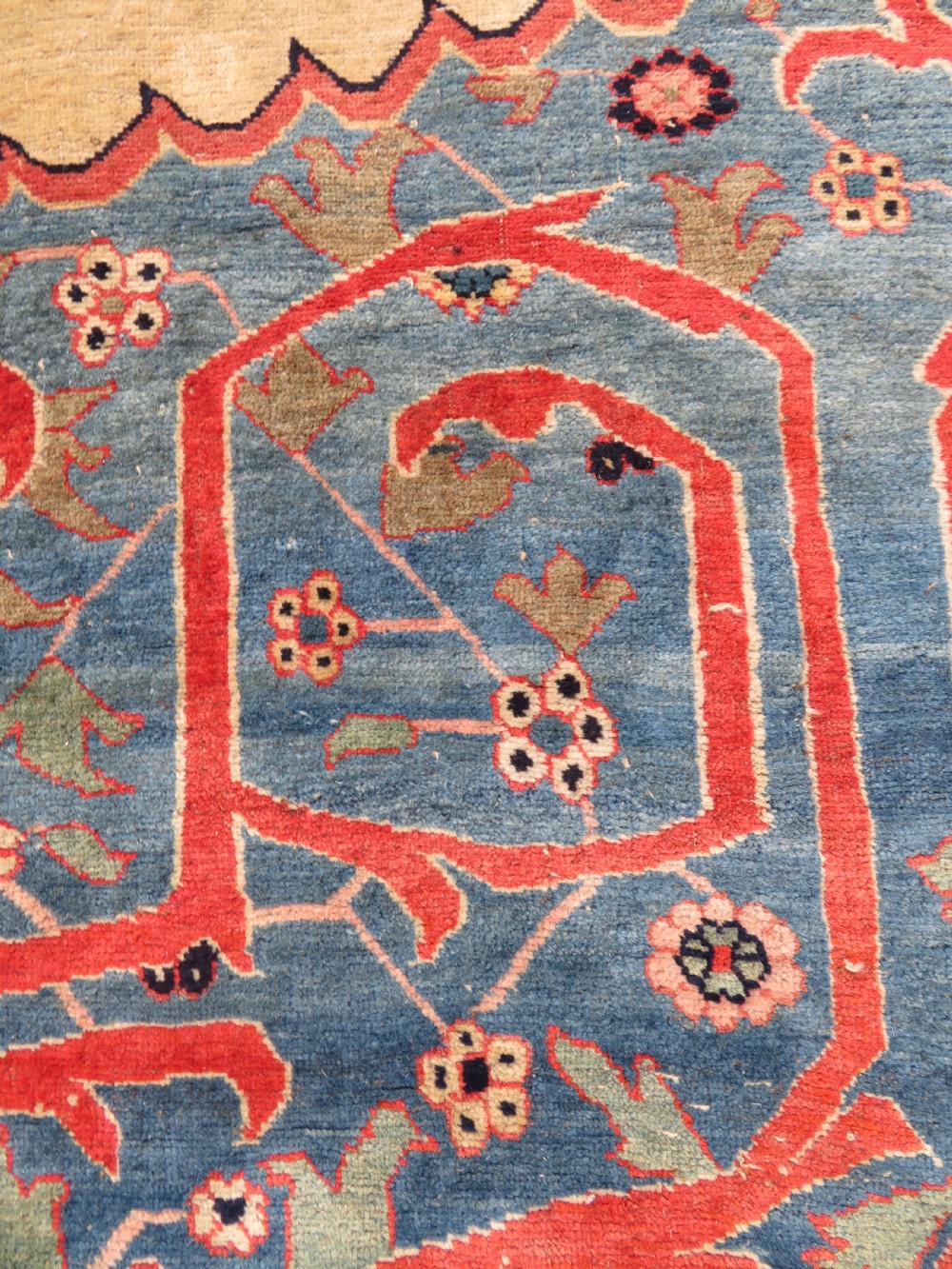 A large hand-knotted antique Persian Bidjar carpet featuring a gold yellow field, central diamond medallion, blue corner spandrels, and a patterned red border. View VIII