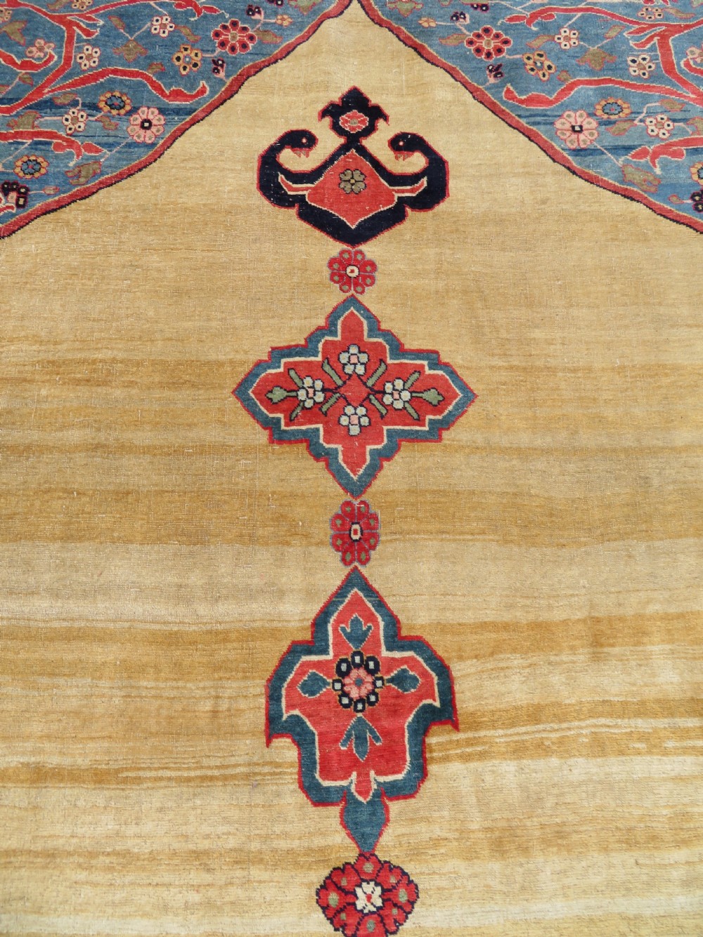 A large hand-knotted antique Persian Bidjar carpet featuring a gold yellow field, central diamond medallion, blue corner spandrels, and a patterned red border. View XIII