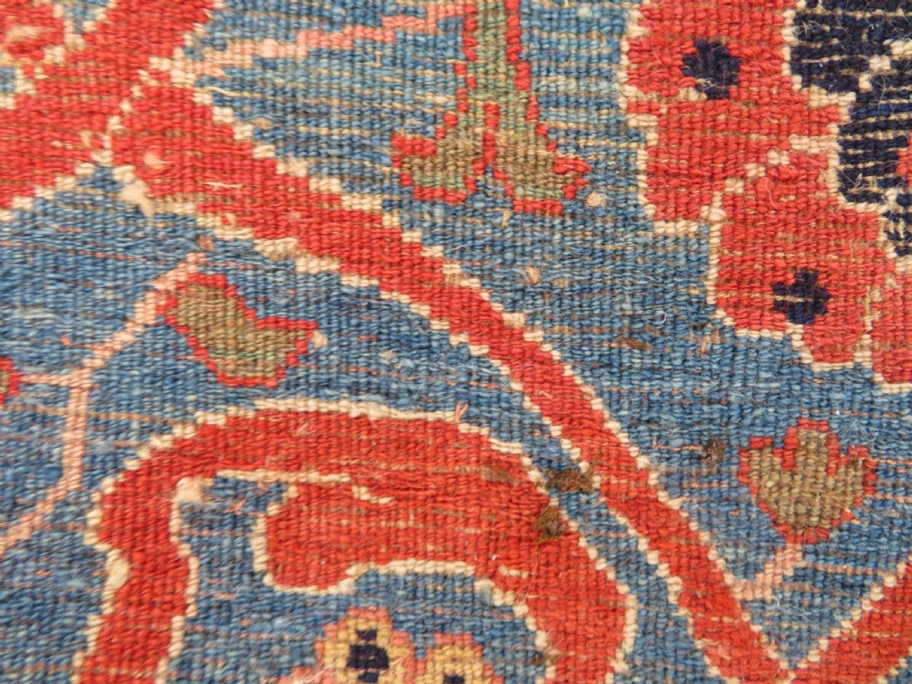 A large hand-knotted antique Persian Bidjar carpet featuring a gold yellow field, central diamond medallion, blue corner spandrels, and a patterned red border. View XXII
