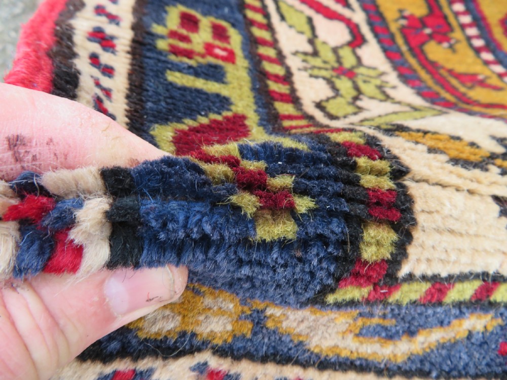 Hand-knotted Anatolian Kirsehir prayer rug featuring a red stepped niche central field with geometric floral motifs and a star, bordered by navy and mustard stripes. View V