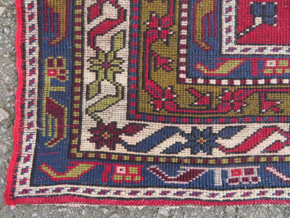 Hand-knotted Anatolian Kirsehir prayer rug featuring a red stepped niche central field with geometric floral motifs and a star, bordered by navy and mustard stripes. View IX