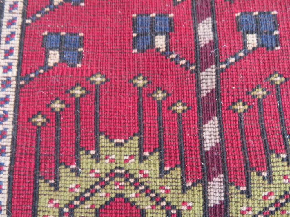 Hand-knotted Anatolian Kirsehir prayer rug featuring a red stepped niche central field with geometric floral motifs and a star, bordered by navy and mustard stripes. View X