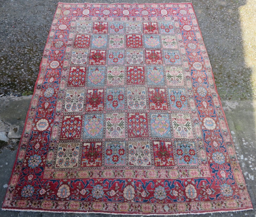 A hand-knotted Persian Qum rug featuring a grid tile pattern filled with floral and animal motifs inside a detailed red border. View II
