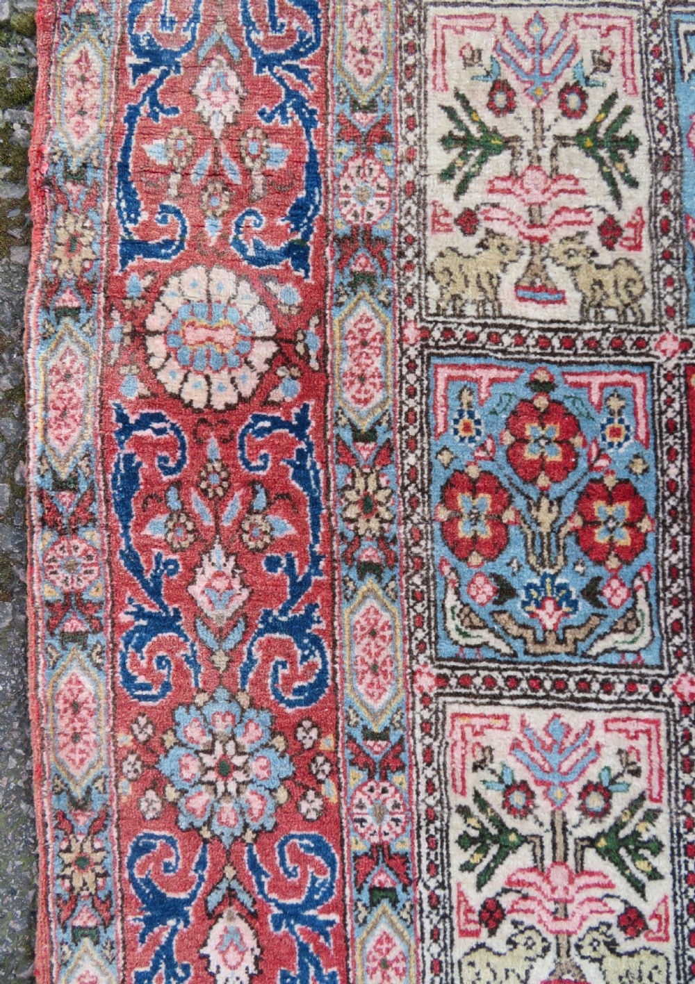 A hand-knotted Persian Qum rug featuring a grid tile pattern filled with floral and animal motifs inside a detailed red border. View VIII
