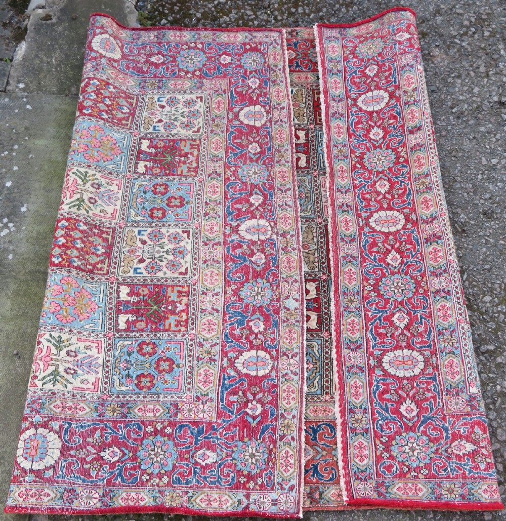A hand-knotted Persian Qum rug featuring a grid tile pattern filled with floral and animal motifs inside a detailed red border. View XI