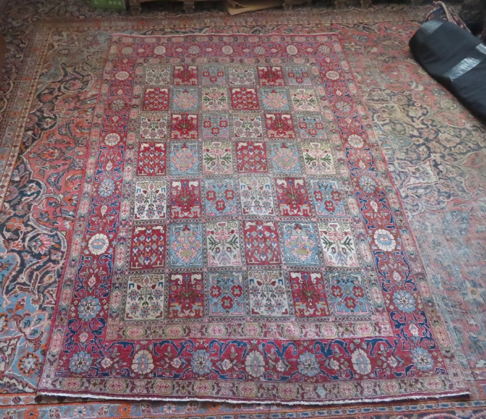 A hand-knotted Persian Qum rug featuring a grid tile pattern filled with floral and animal motifs inside a detailed red border. View XIV