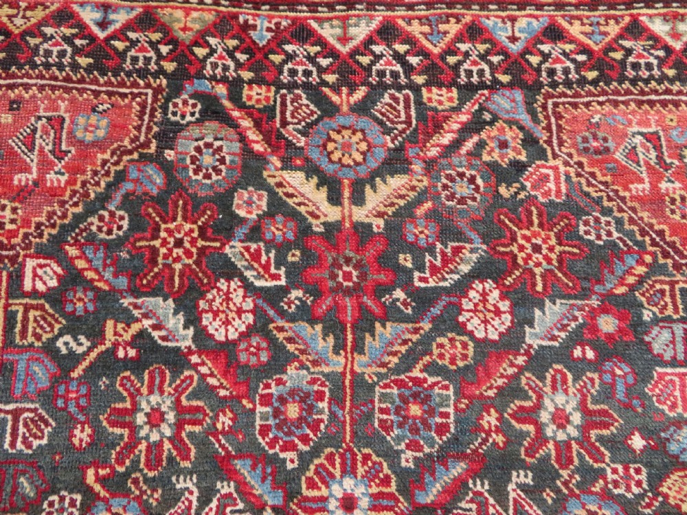 An antique hand-knotted Qashqai wool carpet with geometric bird, botanical motifs, and compound borders in deep red and navy blue. View IX