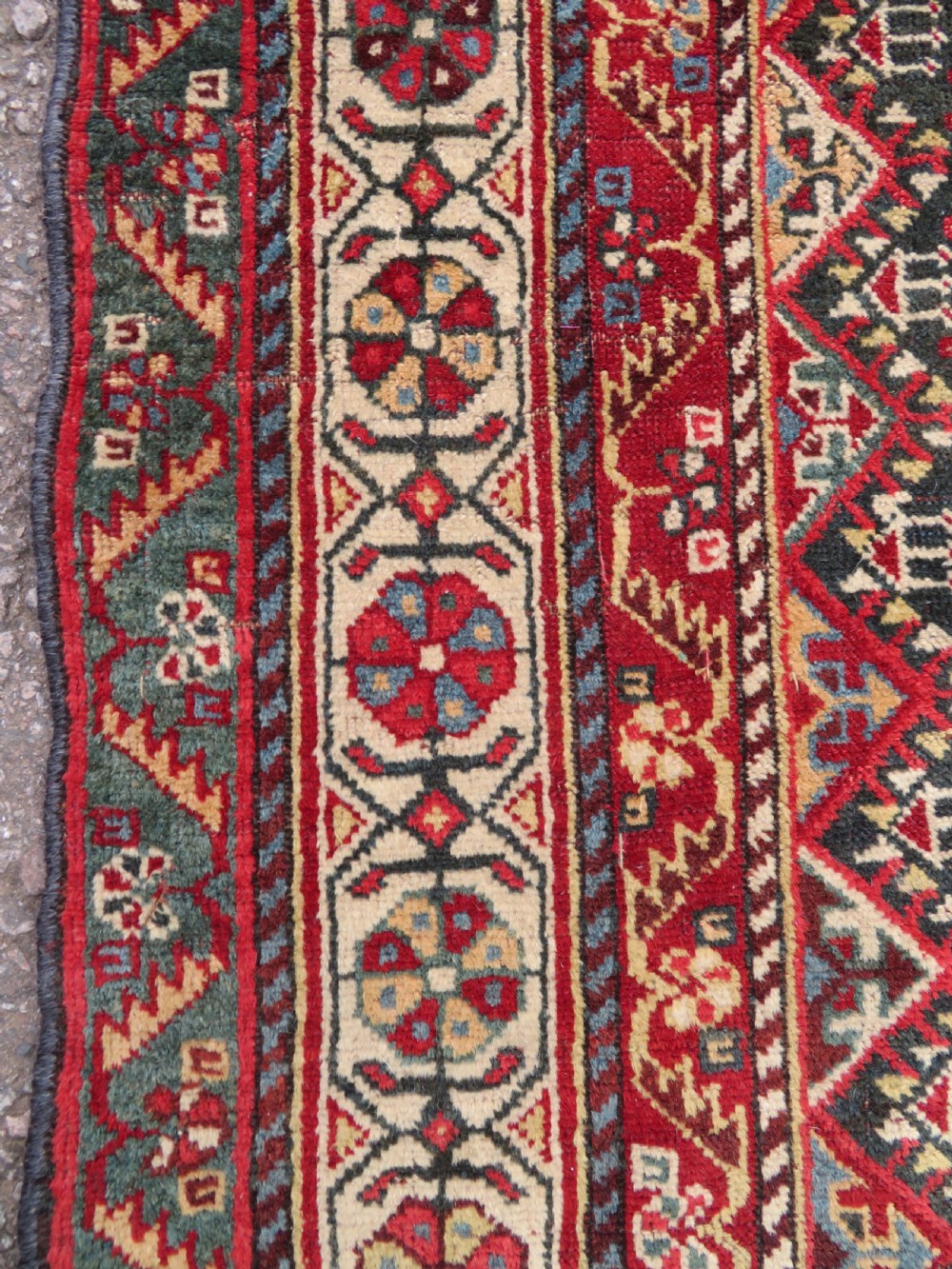 An antique hand-knotted Qashqai wool carpet with geometric bird, botanical motifs, and compound borders in deep red and navy blue. View XI