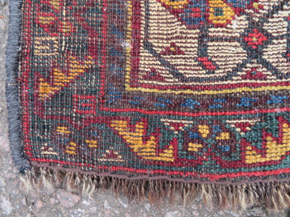 An antique hand-knotted Qashqai wool carpet with geometric bird, botanical motifs, and compound borders in deep red and navy blue. View XVI