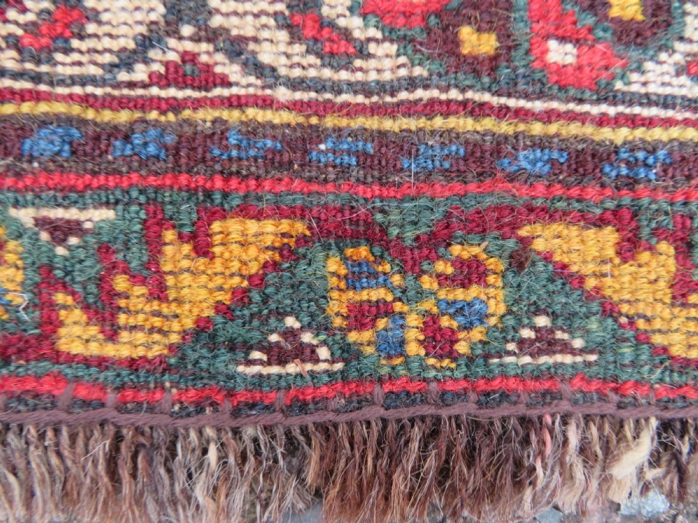 An antique hand-knotted Qashqai wool carpet with geometric bird, botanical motifs, and compound borders in deep red and navy blue. View XVII