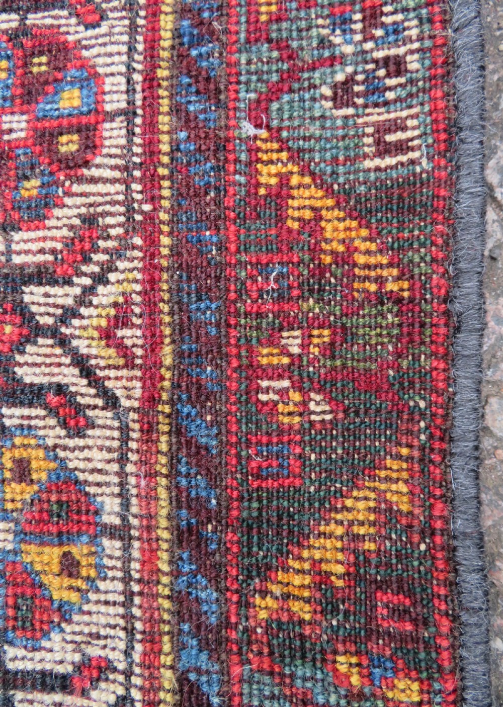 An antique hand-knotted Qashqai wool carpet with geometric bird, botanical motifs, and compound borders in deep red and navy blue. View XIX