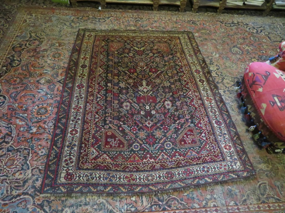 An antique hand-knotted Qashqai wool carpet with geometric bird, botanical motifs, and compound borders in deep red and navy blue. View XXI