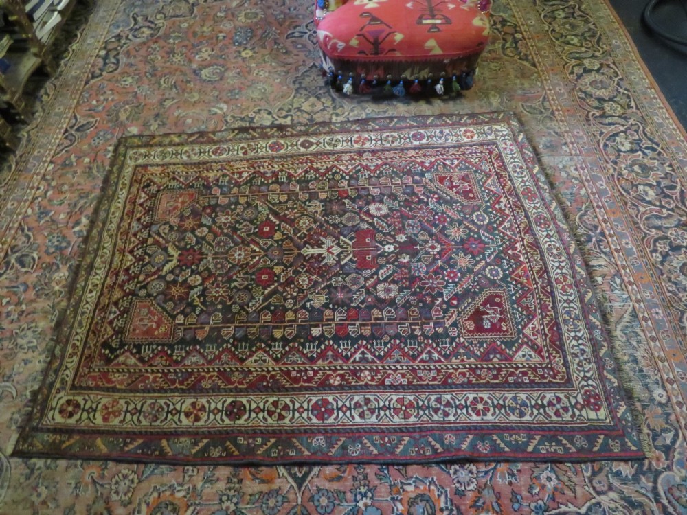 An antique hand-knotted Qashqai wool carpet with geometric bird, botanical motifs, and compound borders in deep red and navy blue. View XXII