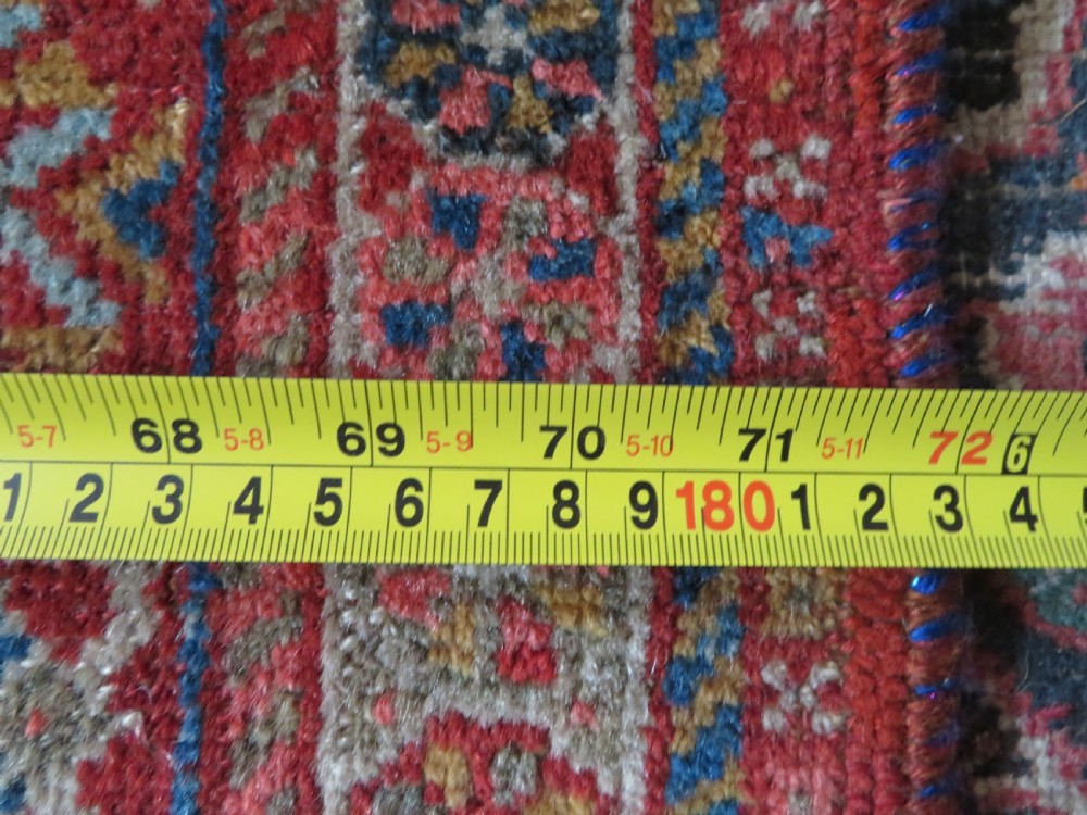 An antique hand-knotted Khamseh tribal carpet featuring multiple diamond medallions and geometric borders in navy blue, terracotta red, and cream wool. View XXV
