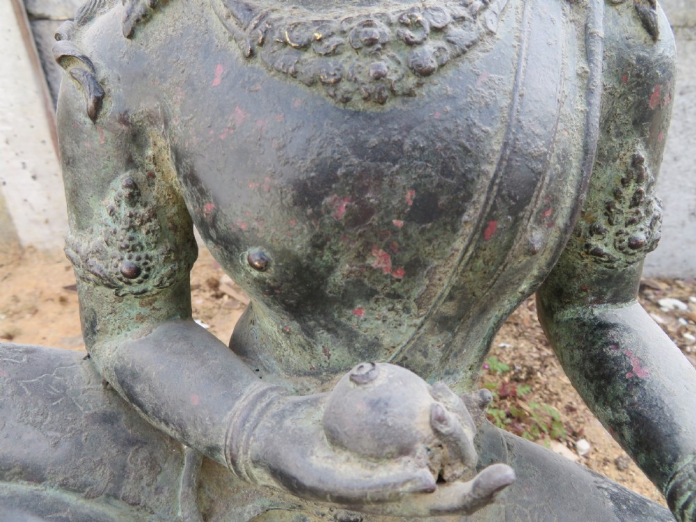 A dark bronze sculpture of a seated Bodhisattva Avalokitesvara featuring an ornate crown, beaded jewellery, and a double lotus pedestal base. View II