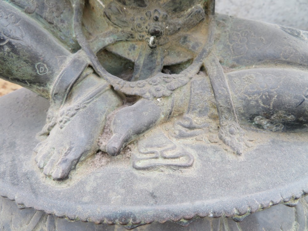 A dark bronze sculpture of a seated Bodhisattva Avalokitesvara featuring an ornate crown, beaded jewellery, and a double lotus pedestal base. View VI