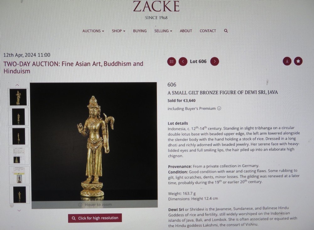 A standing gilded metal statue of a deity on a lotus base holding a lotus stem with an ornate crown and detailed jewellery. View XXII