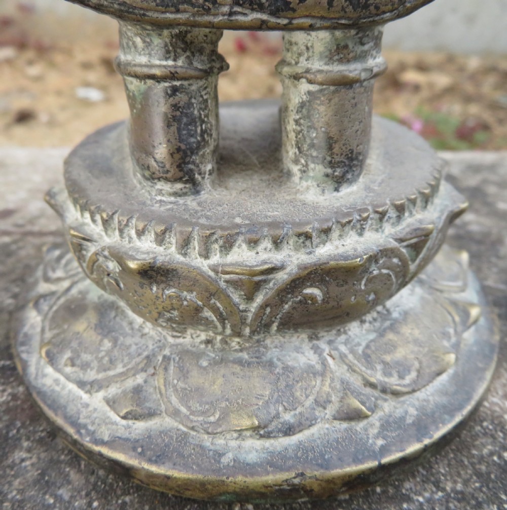 A standing four-armed copper alloy figure of the Hindu deity Shiva on a lotus pedestal with an aged patina. View X