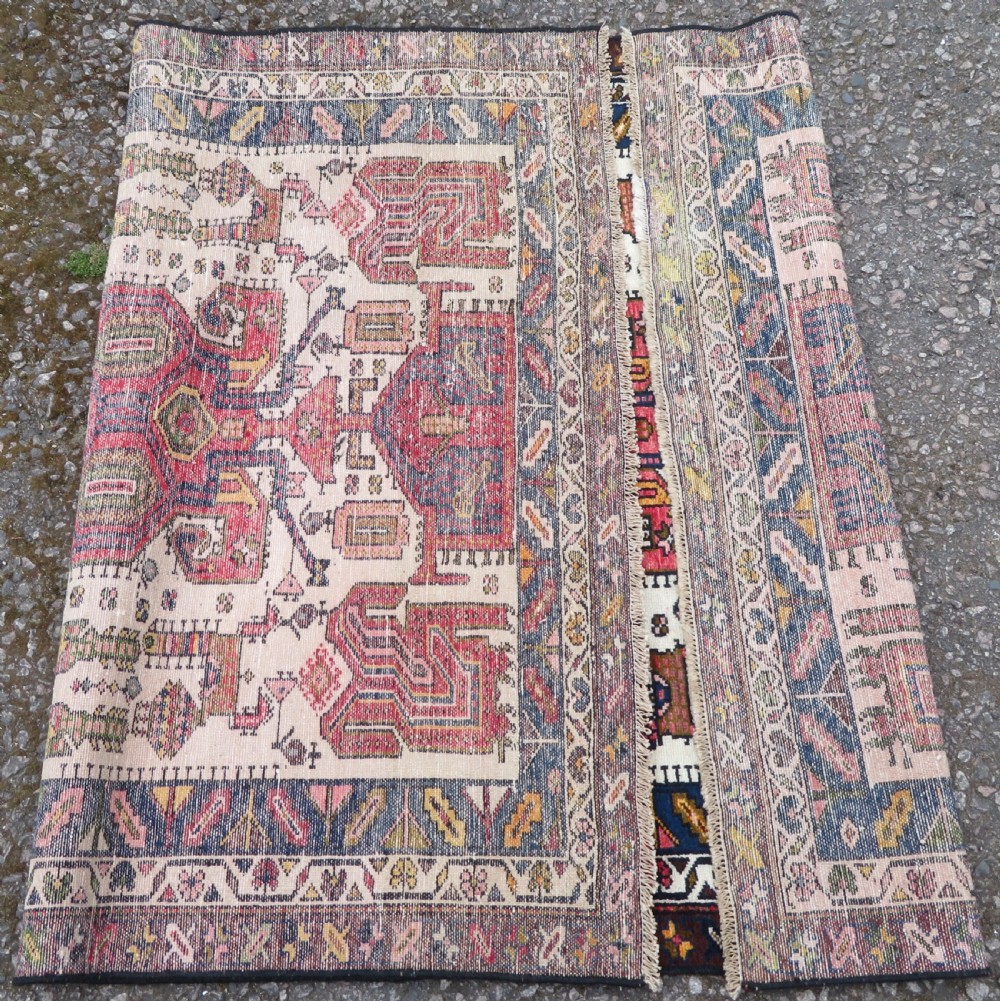 An antique hand-knotted Persian tribal rug featuring a geometric medallion and stylised animal figures in terracotta red, navy blue, and cream. View XII