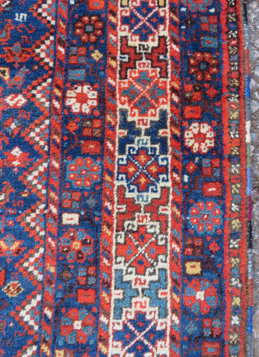 An antique Persian Khamseh carpet featuring three diamond-shaped central medallions and small bird motifs on a dark navy blue field with geometric borders. View XII