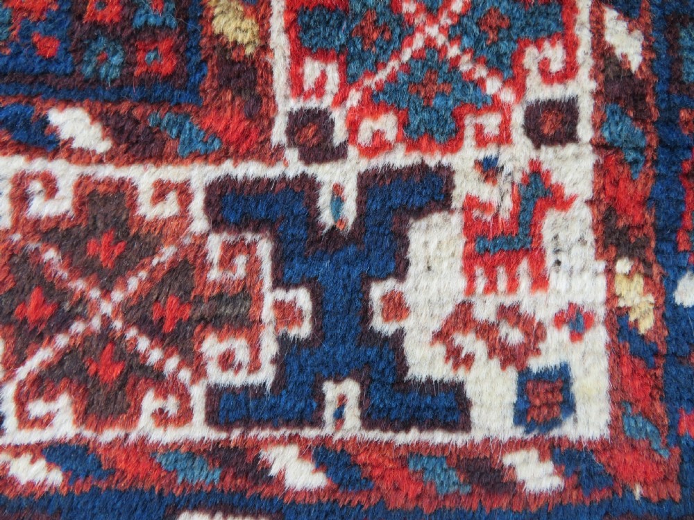 An antique Persian Khamseh carpet featuring three diamond-shaped central medallions and small bird motifs on a dark navy blue field with geometric borders. View XIX