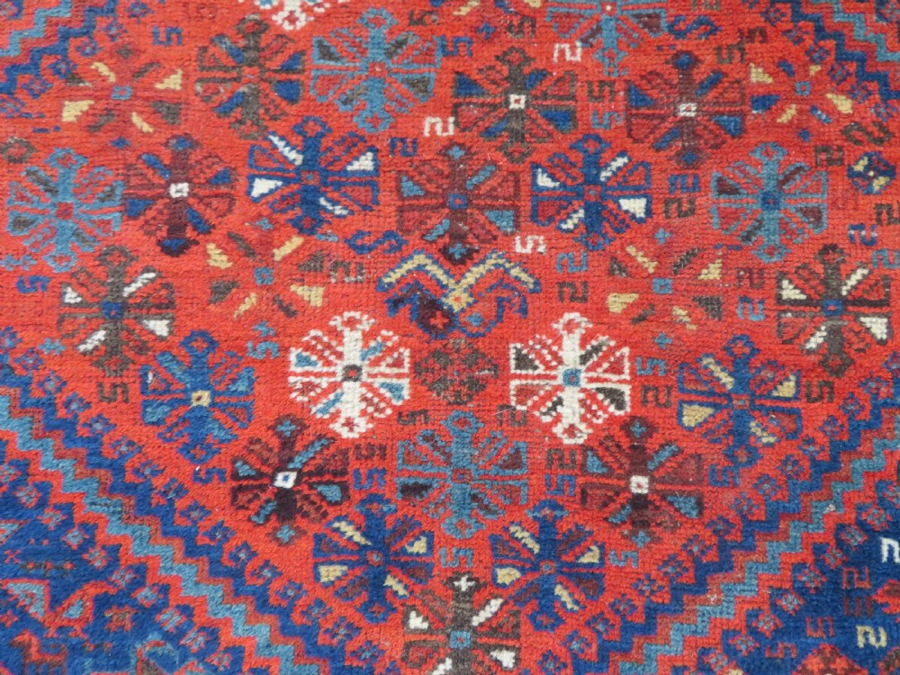 An antique Persian Khamseh carpet featuring three diamond-shaped central medallions and small bird motifs on a dark navy blue field with geometric borders. View XX