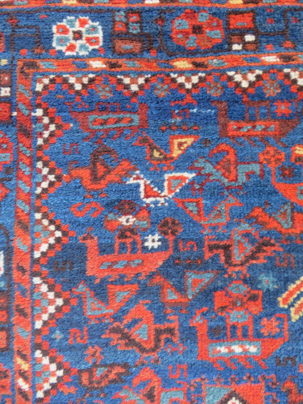 An antique Persian Khamseh carpet featuring three diamond-shaped central medallions and small bird motifs on a dark navy blue field with geometric borders. View XXII