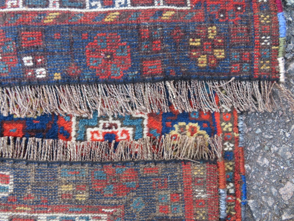 An antique Persian Khamseh carpet featuring three diamond-shaped central medallions and small bird motifs on a dark navy blue field with geometric borders. View XXIV