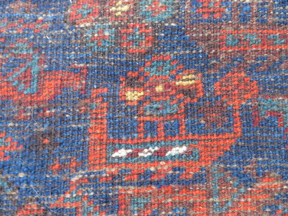 An antique Persian Khamseh carpet featuring three diamond-shaped central medallions and small bird motifs on a dark navy blue field with geometric borders. View XXV