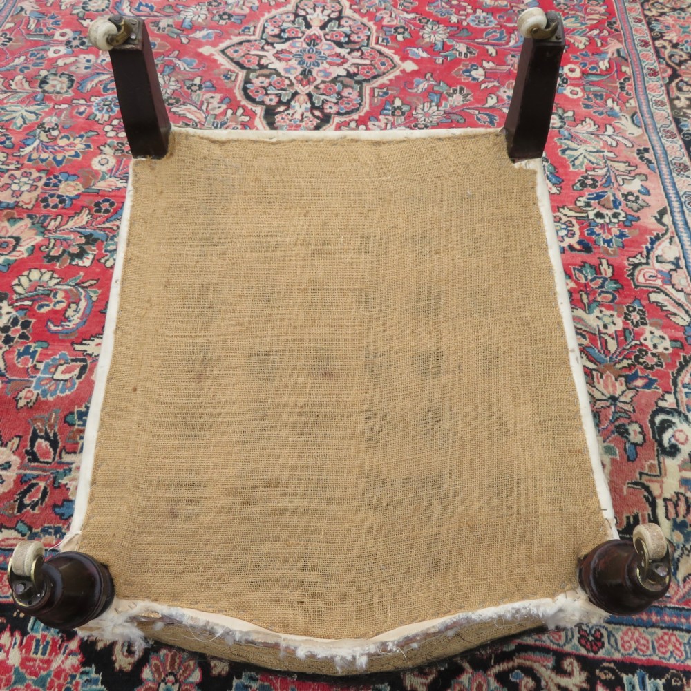 A Howard style low easy chair frame with exposed horsehair seat filling, cream calico back, and turned front wooden legs on ceramic castors. View XI