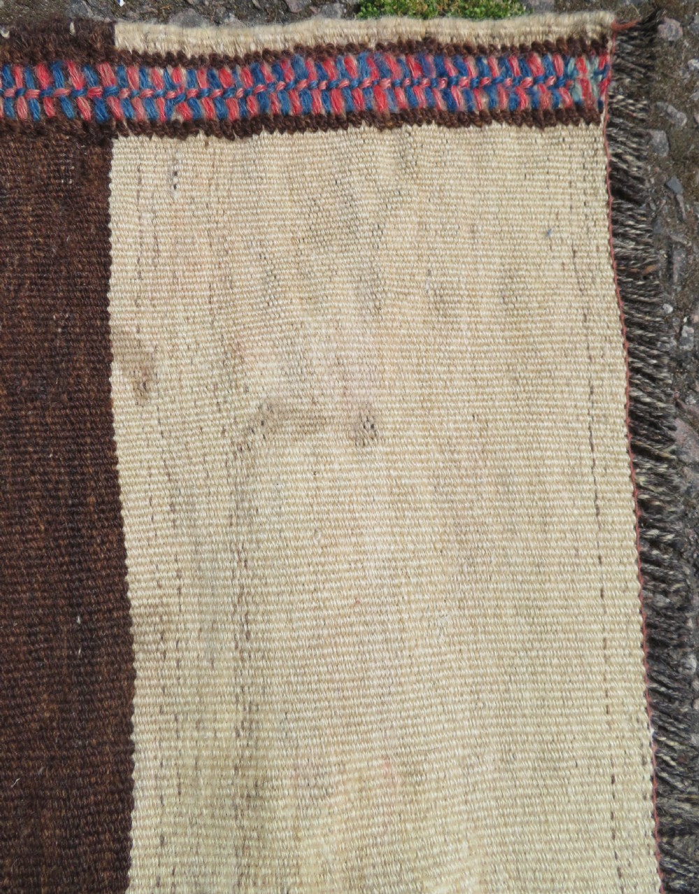 An antique flatweave Kurdish Tasheh wheat sack featuring vertical blue, red, cream, and brown stripes alongside a woven chevron motif. View VI