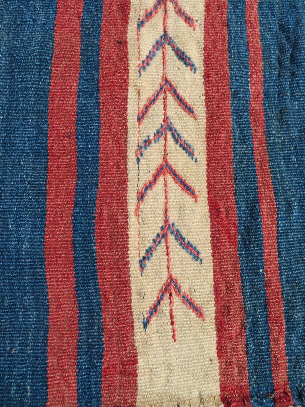 An antique flatweave Kurdish Tasheh wheat sack featuring vertical blue, red, cream, and brown stripes alongside a woven chevron motif. View VIII