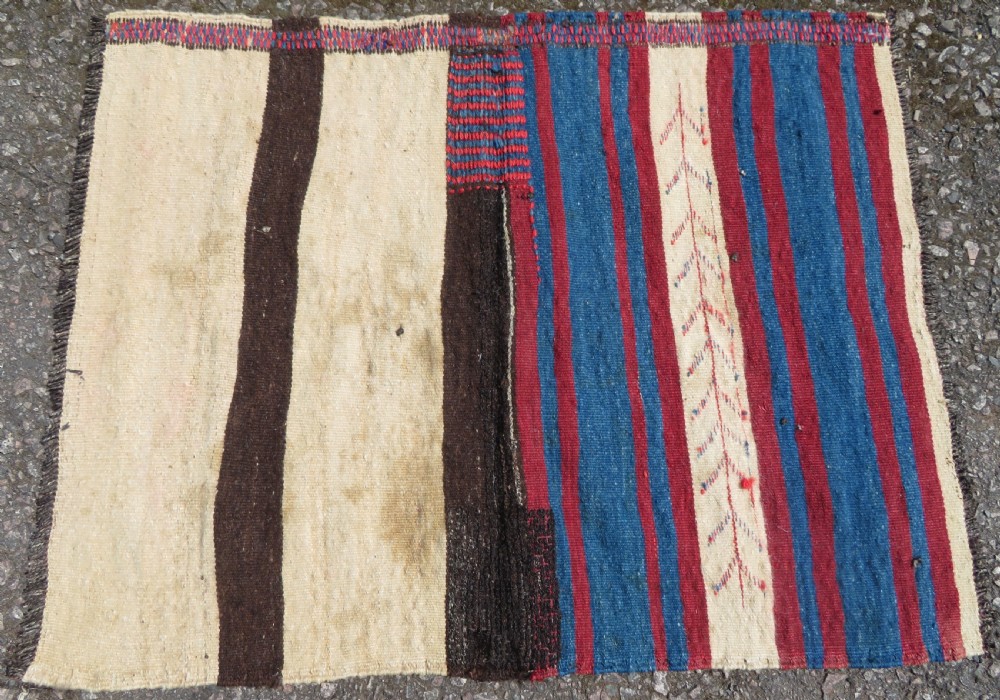 An antique flatweave Kurdish Tasheh wheat sack featuring vertical blue, red, cream, and brown stripes alongside a woven chevron motif. View IX